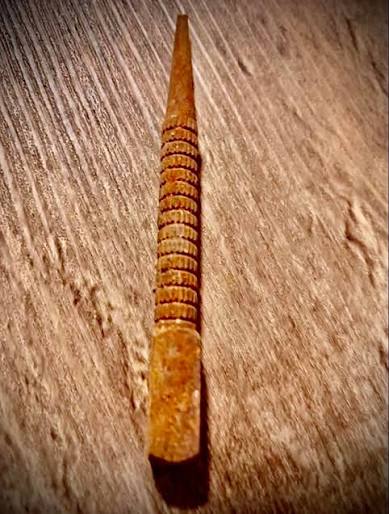 What is this rusty pointed object found on a country road?