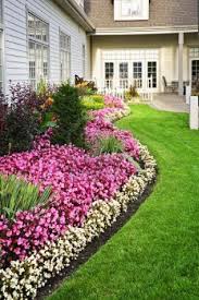 Flowerbed Of Colorful Flowers Against Wall With Windows Front Yard Landscaping Design Flower Landscape Garden Landscape Design