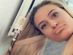 Woman curls hair using radiator