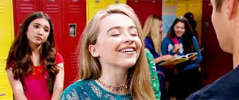 maya + biting her lip and smiling at lucas