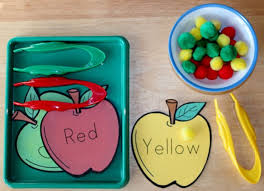 Pinch colored sand and placed it on a glued leaf outline. Apple Color Pom Pom Sorting Tray Activity For Preschoolers A Fun Fine Motor Activity That Promotes Color R Apple Preschool Preschool Apple Theme Apple Lessons