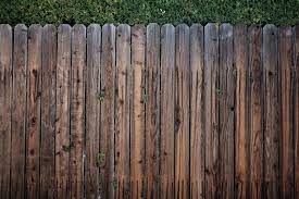 Wooden garden fence section in closeup in the sun with shadows. 5 Ways You Can Repurpose Your Wooden Fence Panels Woodz