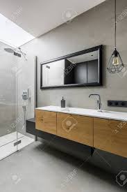 Maybe you would like to learn more about one of these? Modern Grey Bathroom With Walk In Shower And Wooden Cabinets Stock Photo Picture And Royalty Free Image Image 91139879