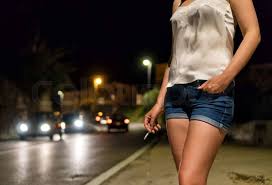 Prostitute with cigarette waiting for ...