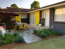 Greg 0414 793 171 email: Bold Yellow Feature Wall In Backyard With Black Painted Brick And Tiled Pathway And Garden And Porch Inspirations Paint