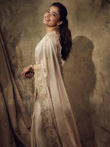 Rashmika Mandanna (@rashmika_mandanna) radiates understated elegance in an  ivory embroidered saree paired with a richly embellished blouse that adds a  regal contrast to the look. The delicate detailing along the drape, combined