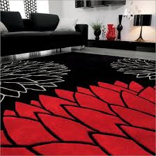 The cozy living room in black and white themes features a white table on the black and white pattern carpet that matches black and white wall decor. This Room Is Colored In Black And White With Red As An Accent Beautifully Done Via Dragica Aveledo Living Room Red Home Decor Apartment Decorating Livingroom