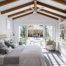 Mid Sized Farmhouse Master Bedroom In San Francisco With White Walls Ceiling Beams French Doors Master Bedrooms Decor Rustic Bedroom Design Bedroom Addition