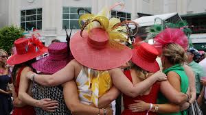 Photos show people gathered at the famed race track in traditional derby attire and face masks. Gusxzjcf1brtfm