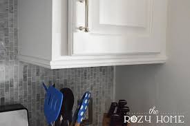 Easy And Inexpensive Cabinet Updates The 15 Minute Fix Adding Trim To The Bottom Of Cabinets The Rozy Home Update Cabinets Kitchen Cabinets Trim Cabinet Trim