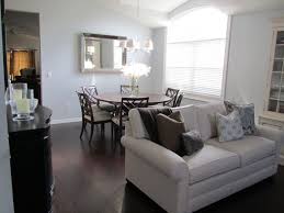 A light cream marble table sits on a white and beige cowhide rug. My Favorite Room Grey Wood Floors Living Room Living Room Wood Floor Living Room Furniture Arrangement