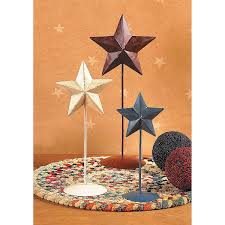 For holidays or anytime, use found objects to create a natural wall hanging for indoors or outside. Rustic Americana Standing Stars Discontinued Americana Home Decor Rustic Star Star Decorations
