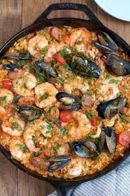 Easy Delicious And Flavorful Seafood Paella That You Can Make At Home And You Don T Need A Paella Pan Seafood Dinner Paella Recipe Seafood Saffron Recipes