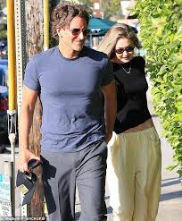 Bradley Cooper, 51, parecia chocantemente jovem em um raro passeio em um ponto badalado de Los Angeles, sentado com a namorada Gigi Hadid, 31