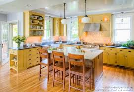 Traditional Yellow Kitchen With A Custom Wood Island Yellow Kitchen Cabinets Yellow Kitchen Wood Kitchen Cabinets