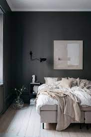 Scandinavian Bedroom Dark Grey Walls Textiles In Soft Beige Hues Wall Art And Wooden Floors Stylish Bedroom Decor Bedroom Design Scandinavian Bedroom