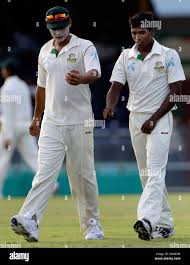 Bangladesh's captain Mashrafe Mortaza, left, gives instructions to his  bowler Rubel Hossain during the second day of the first Test match at Arnos  Vale cricket ground, in Kingstown, St. Vincent, Friday, July