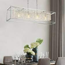 If you have a rectangular table but want to use contrasting shapes in your fixture, suspending two or three small ones over your table instead of a single fixture is a chic and inspired way to create texture in a room. Contemporary Rectangular Chrome Frame Crystal Chandelier Sofary