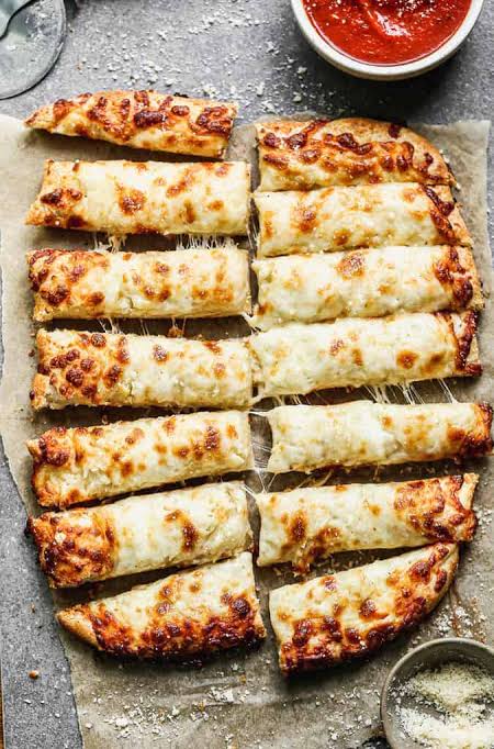 Savory cheesy breadsticks made with standard yeast pizza dough., AI generated