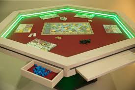 The gaming tables are freakin' modular, and allow people to add accessories plus, the tables apparently make it really easy to eat and game, which is a combination for the ages. Rolldark Events Merch