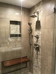 Great Looking Bathroom Shower Remodel With Sliced Pebble Mosaics And Retractable Teak Bench Brizo Virag Shower Remodel Bathroom Design Bathroom Remodel Master