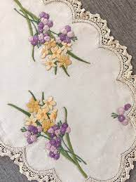 Another place you see border designs is on items such as bags purses and totes. Vintage Embroidered Table Linen Hand Stitched Floral Embroidery Of Daffodil Silk Ribbon Embroidery Patterns Embroidery Neck Designs Peacock Embroidery Designs