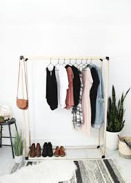 Stabilize your wooden clothes rack with a shelf along the bottom, which doubles well for storing shoes. Diy Clothing Rack