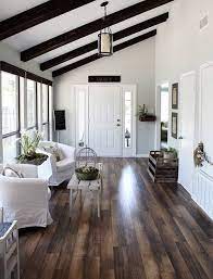 It is recommended to integrate at least two lighting fixtures in a room with a sloped ceiling to help stabilize the light beams and provide uniform illumination throughout the whole space. The Ultimate Guide To Flooring Joanna Gaines House Living Room Wood Floor Fixer Upper