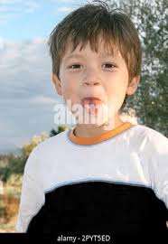 outdoor portrait with a little boy who making grimaces Stock Photo