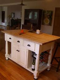 French country kitchen with white and gold french range hood in an arched cooking alcove. Amish Made Large French Country Kitchen Island From Dutchcrafters