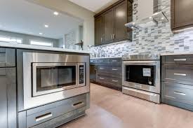 Kitchen With Neutral Wood Cabinets Mosaic Tile Backsplash Chimney Hood Fan New Hampshire Model By Kimberly Homes Jagare Kitchen New Home Designs New Homes
