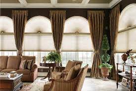 The fabric folds offer warmth and make the room's view a focal point. Window Treatment Ideas For Large Windows Vizimac Window Treatments Living Room Living Room Windows Arched Window Treatments
