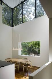 Two square brown wooden tables and white sofa, interior, design. Window Designs For Modern Houses Magnificent Glasswork In Residential Architecture