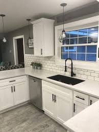 White Shaker Cabinets With Solid Surface Countertops And Flat Black Handles Diyk Modern Kitchen Room Kitchen Backsplash Designs White Shaker Kitchen Cabinets
