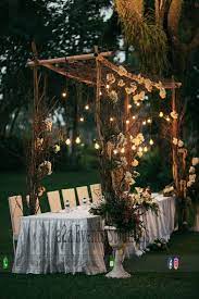 Open Air Stylish Eastern Table Decor With Hanging Bulbs Imported Flowers Outdoor Wedding Decorations Outdoor Wedding Wedding Invitations Rustic Country