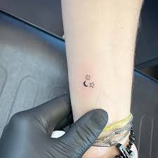 Carved with dark ink, the sun moon tattoo looks elegant and stands for the symbiotic relationship between male and female. Sun And Moon Tattoo Star Tattoo Designs For Women