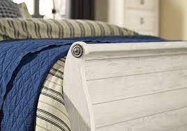 Faux plank detailing incorporates a classically rustic touch, so homey and comforting. Willowton Whitewash King Sleigh Bed