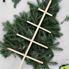 This tree stacked against the wall and decorated with mini christmas trees, ornaments, candles, greeting cards and gift boxes, makes a powerful impact because of its simplicity. Space Saving Christmas Tree Craftgawker