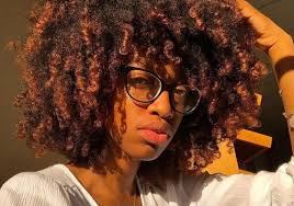 Medium bob with long parted bangs. 25 Afro Hairstyles That Embrace Your Natural Texture