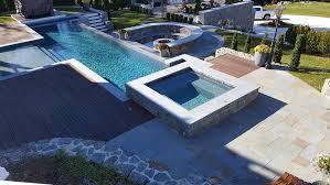The fun part of designing your custom inground gunite swimming pool is that you aren't limited to just a square, rectangular or other prefabricated shapes in addition to designing your pool any shape that you like, you can also add any pool feature you would like, allowing you to build your dream oasis. Inground Pool Installation The Patio Company Massachusetts