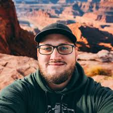 Grown man enjoys playing with blocks and vehicles