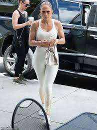 The beauty had the hood of the dress over her long blonde highlighted tresses, with her white sneakers half tied. Jennifer Lopez Showcases Her Famous Backside As She Heads To The Gym Daily Mail Online