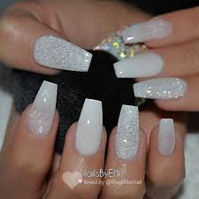 The nails have yellow tips that blend into a neutral tone and each nail is decorated with sparkling crystals. Stylish Belles Cute Coffin Shaped Light Grey Acrylic Nails With