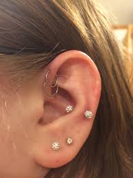 this is my snug and double helix piercings cute ear piercings piercings piercing
