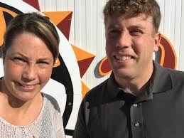 Venae Watts and Adam Mueller 5th Generation of Minerva Dairy took a ride up  the boom for a selfie!! Bob Strom local artist is working