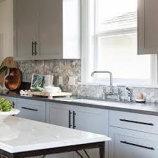This is an amazing kitchen backsplash idea which you should definitely consider getting done if a sassy and spunky kitchen is what you're looking. Grey Kitchen Cabinets White Countertops Design Ideas