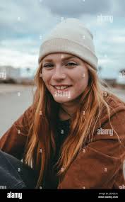 Street portrait of charismatic young woman in formal suit and eyeglasses  walking