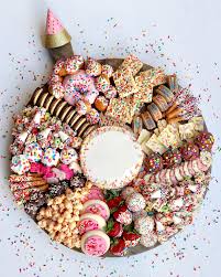 Take everyone for a stroll down memory lane with photos of the guest of honor in the form of balloons, candles, cupcakes, and party hats. Birthday Dessert Board The Bakermama