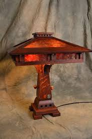 The central art glass golden sunflower motif and vines are set in a field of aubergine granice colored glass. 210 Craftsman Lamps Ideas In 2021 Craftsman Lamps Lamp Craftsman