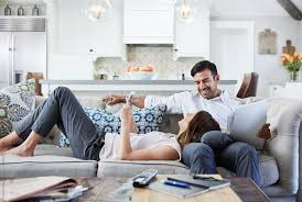 Case of young couples at solusi university. Young Couple Relaxing On Sofa Looking At Mobile Phone After Work By Trinette Reed Telecommuting Stocksy United